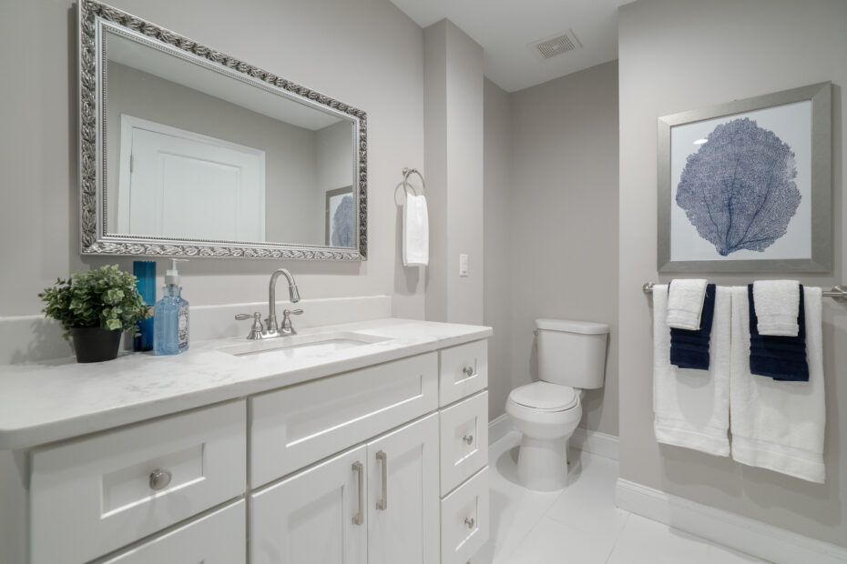 Modern bathroom with white cabinetry and remodeled by Veteran Built Homes.