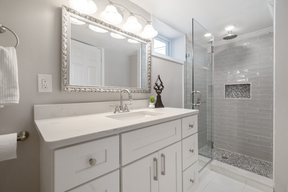 Elegant bathroom in Washington, D.C. with white cabinetry and a modern shower, remodeled by Veteran Built Homes.