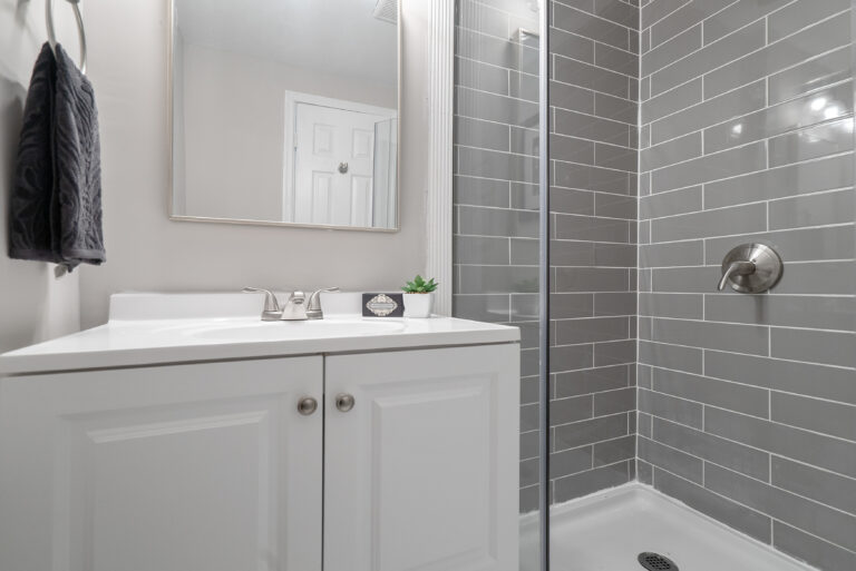 Modern renovated bathroom in Washington, D.C. featuring a shower stall and sink, remodeled by Veteran Built Homes.