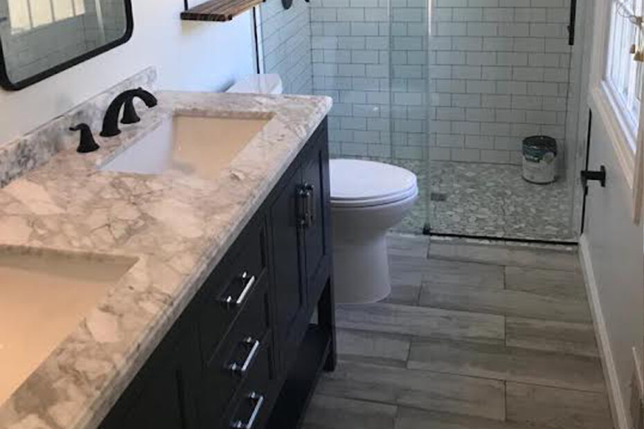 A modern bathroom featuring a shower and sink, showcasing upgraded flooring installed in Northern Virginia for a fresh functional look.