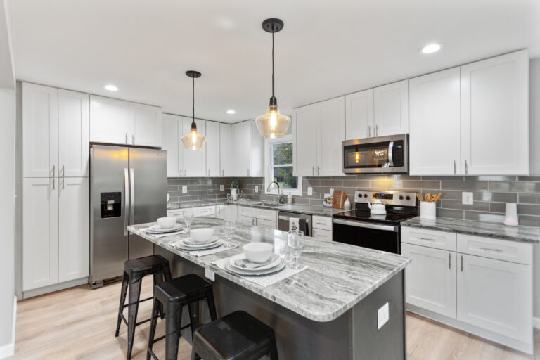 Modern kitchen with white cabinets and stainless steel appliances, renovated by Veteran Built Homes in Northern Virginia.