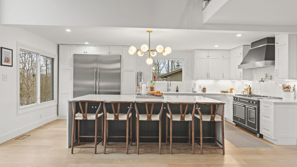 A modern kitchen in Woodbridge, Virginia, featuring a central island and a refrigerator, showcasing a functional and stylish cooking space.