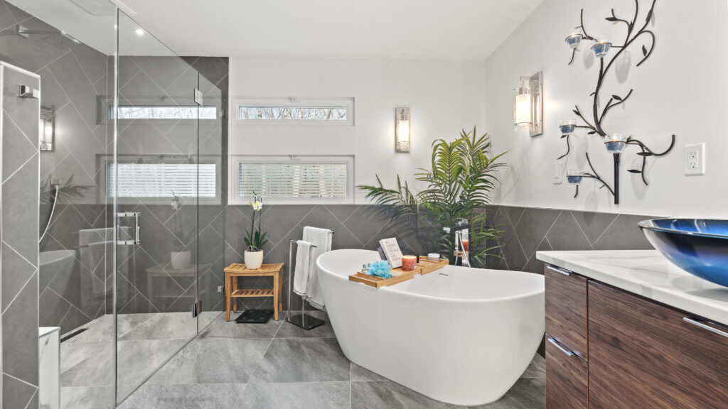A modern bathroom featuring a spacious tub and a sleek shower area, designed for comfort and relaxation.