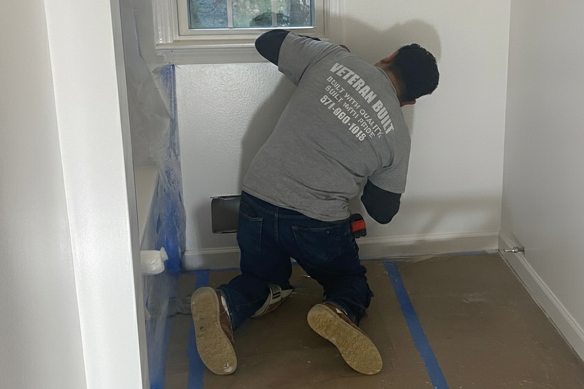 Handyman painting an interior wall in a Northern Virginia home