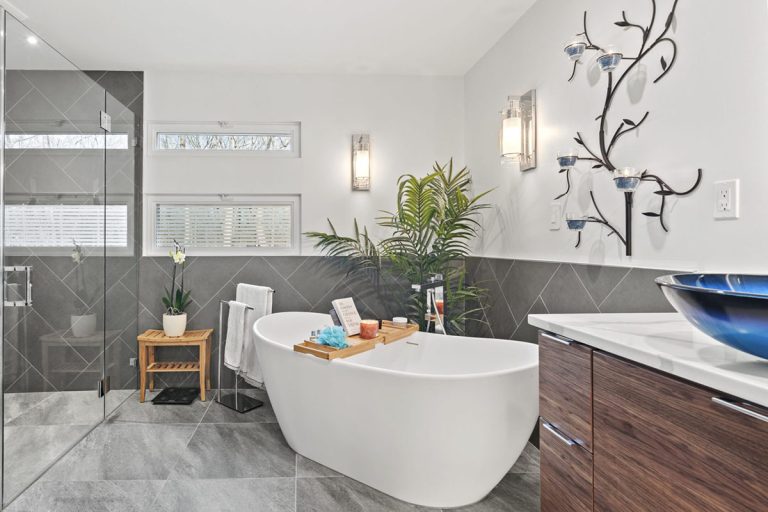 Freestanding soaking tub, double vessel sinks, and floating walnut vanity